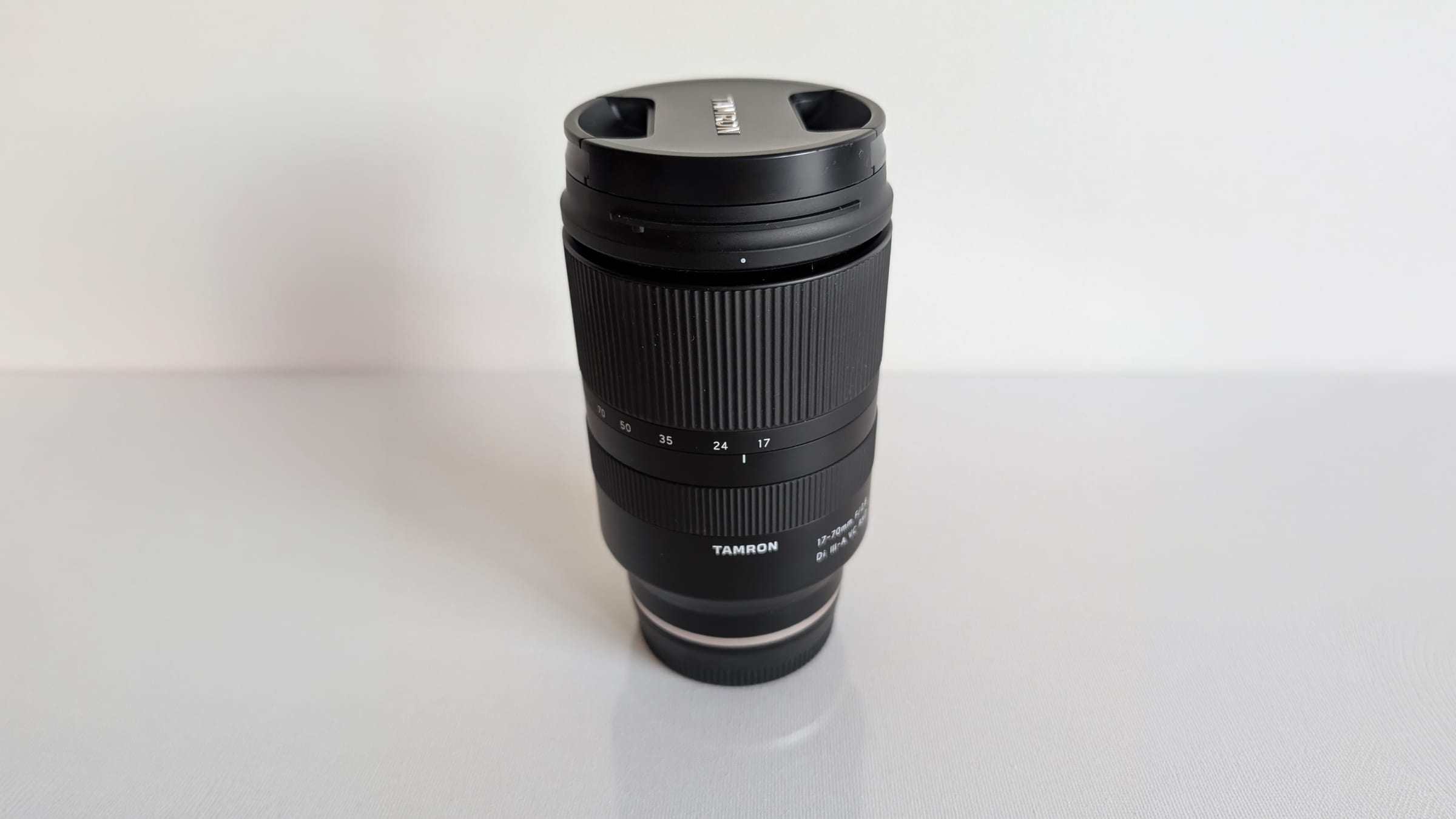 Tamron 17-70 mm f/2.8 lens standing on its mount cap
